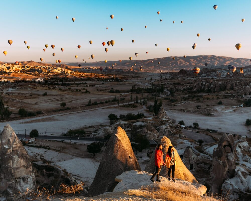 man-and-woman-greet-the-dawn-among-balloons-coupl-2025-01-08-20-35-55-utc